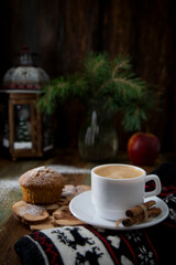 Cup of coffee with cinnamon and homemade cupcake in New Year's entourage