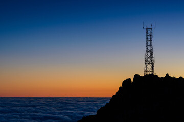 Silhouette of mast high up on mountain