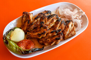 Chicken wings barbeque in a dish with BBQ grill sauce . Izgara tavuk kelebek sis kanat. Tavuk sis, gogus.