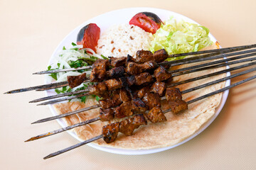 Beef steak grill with rice pilaf, fried potatoes, grilled pepper and tomatoes.Mix Platter with Beef rips, Cutlets, Potatoes and Sauces.