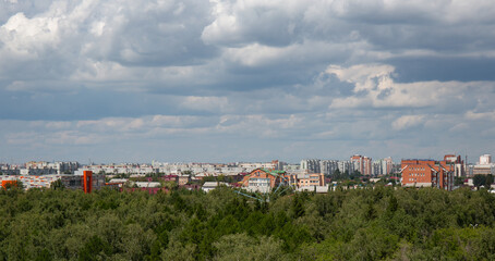 View of the buildings from the Ferris wheel in the park named after the 30th anniversary of the Komsomol of Omsk in summer