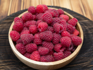 Wooden bowl of raspberries.