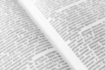Texture of a blurry text in an open periodical or a book for the background. Vector diagonal image of the magazine. Words or information for the template. Black and white colors
