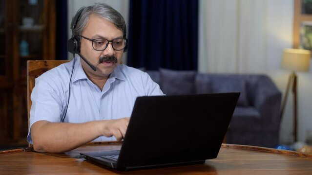 An Indian businessman on an online business video call - office meeting  remote work  foreign client meeting . A middle-aged man in his late forties working from home - distant communication  remot...
