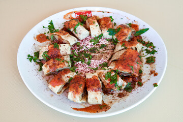 Turkish and Arabic Traditional Ramadan doner kebab with tasty tomato sauce and rice or turkish pilav in white plate on wood table background. ( , Iskender, ekmek arasi pilav ustu doner, doner durum )