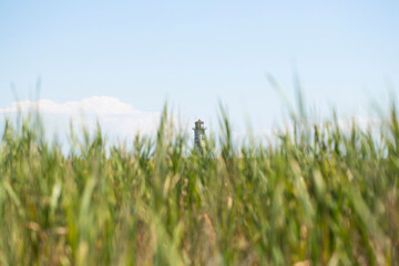 the lighthouse is old. The lighthouse stands against the sky. There is a place to record.