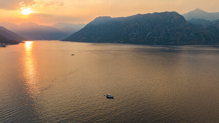 aerial view on bay over the water during sunset with mountains on backgorund
