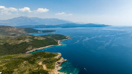 aerial view of rocky coast beach with blue water
