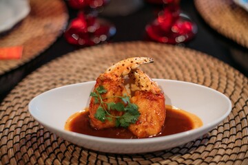 A ready-made dish of fresh red Kamchatka crab legs on the table in the restaurant hall.  Cooked crab meat in a shell on a plate