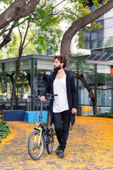Naklejka premium student walking with bike in the university campus