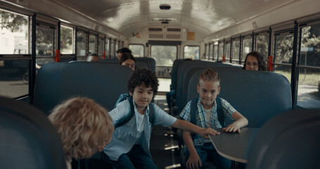 Diverse school teens getting out schoolbus. Children leaving academic shuttle.