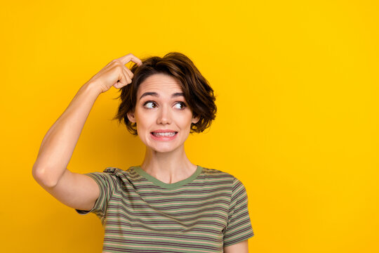 Photo of young pretty woman scratching head oops forgot credit card cafe looking empty space isolated on bright yellow color background