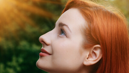 Close-up female inspired pretty profile face attractive model teenage beautiful redhead girl stands...