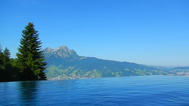 Infinity Swimming Pool with Mountain Peak View in a Sunny Summer Day From Burgenstock, Nidwalden, Switzerland.