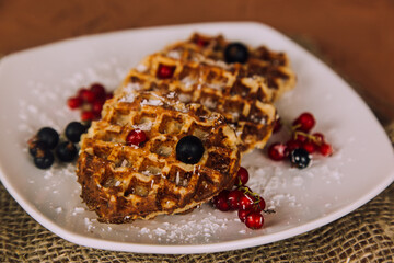 Homemade waffles with berries. Berry Belgian Waffle with raspberries. Culinary, cooking, bakery concept.