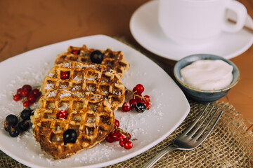 Homemade waffles with berries. Berry Belgian Waffle with raspberries. Culinary, cooking, bakery concept.