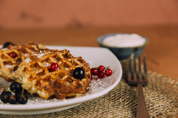 Homemade waffles with berries. Berry Belgian Waffle with raspberries. Culinary, cooking, bakery concept.