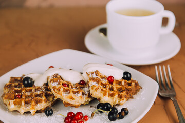 Homemade waffles with berries. Berry Belgian Waffle with raspberries. Culinary, cooking, bakery concept.