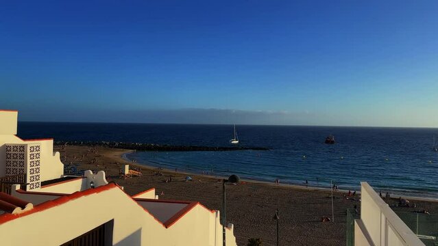 Aerial footage of Los Cristianos beach in Tenerife, Spain, during the day in the early morning