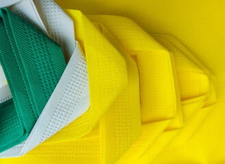 yellow and green ties. Non-woven bag straps are green, yellow and white. a set of stacked and...