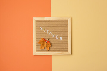 Yellow Hygge Letterboard on Yellow and Orange Autumn Background Message October on Letterboard Top View Horizontal Maple Leaf Cozy Autumn Background