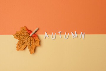 Message Autumn and Fake Maple Leaf on Yellow and Orange Background Seasonal Holiday Background