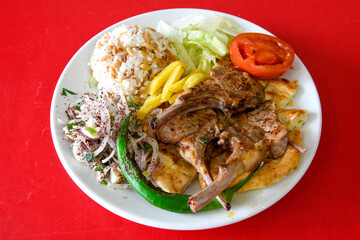 Beef steak grill with rice pilaf, fried potatoes, grilled pepper and tomatoes.Mix Platter with Beef rips, Cutlets, Potatoes and Sauces.
