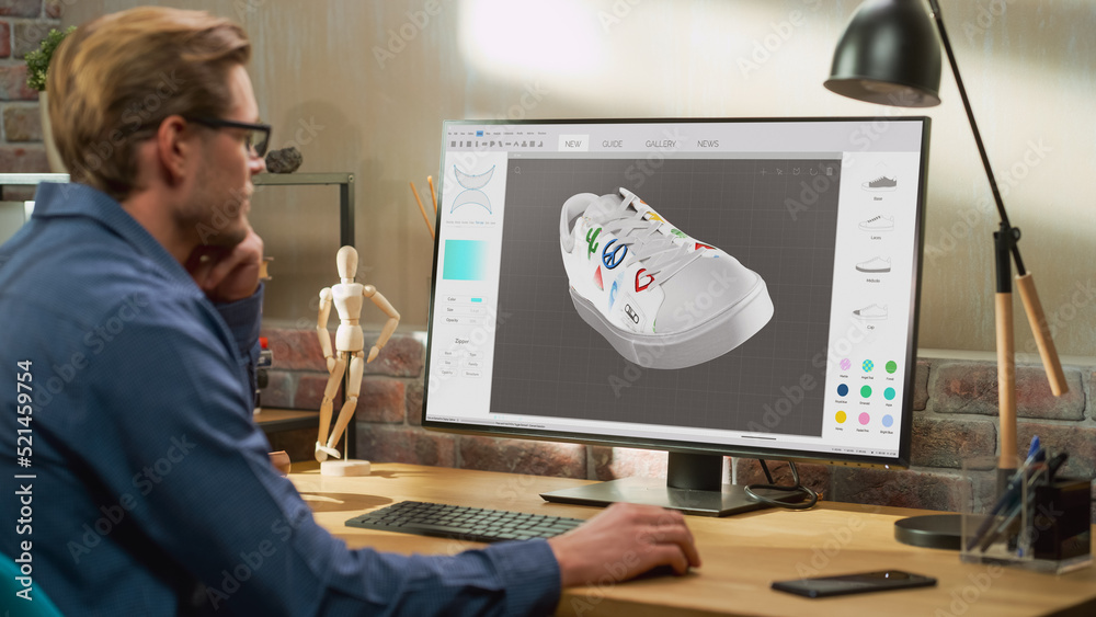 Poster Young Male Footwear Designer Works on 3d Model of Shoe and Change Colours on It While Working on Desktop Computer in Creative Space. Shoe Production Procedure Concept.