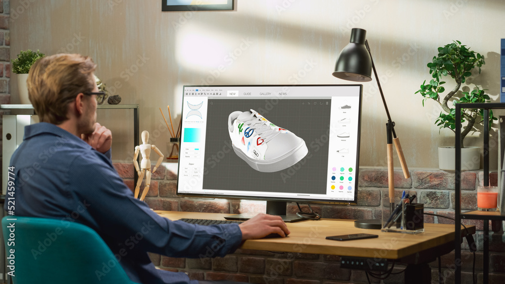 Leinwandbilder Young Male Footwear Designer Works on 3d Model of Shoe and Change Colours on It While Working on Desktop Computer in Creative Space. Shoe Production Procedure Concept.