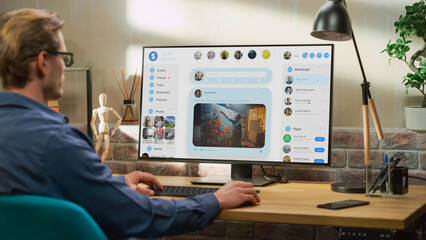 Young Handsome Man Using Desktop Personal Computer to Check Social Media Wall Feed, Live Stream...