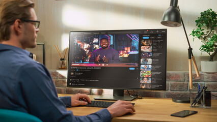 Handsome Man Watching Video Sharing Service Mock-up Where African American Influencer Talks About Lifestyle. Celebrity Blogger Having fun. Interface with Related Streams, Likes, Comments.