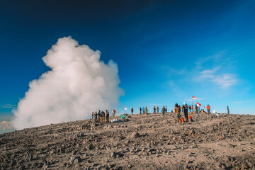 A group of climbers celebrate the success of climbing the peak of Mount Semeru, the highest mountain in Java island, Indonesia.