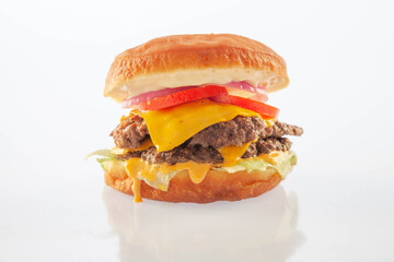 Double decker brioche donut cheeseburger with cheese tomatoes and onion. - obrazy, fototapety, plakaty