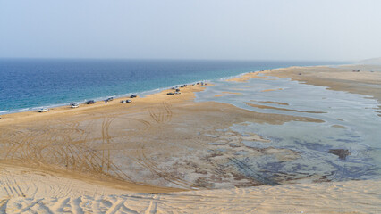 qatar adventurous place khor al udeid ,sea line beach during sunset.