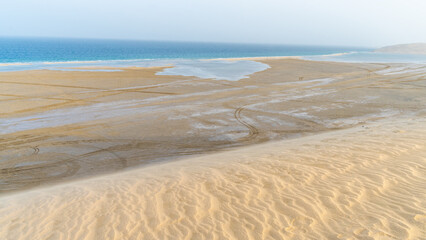 Fototapeta na wymiar qatar adventurous place khor al udeid ,sea line beach during sunset.