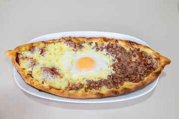 Turkish pita with minced cubed meat and cheese (Turkish name: Kiyma Kusbasi kasarli pide)
