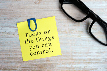 Motivational quote on sticky yellow note - Focus on the things you can control.