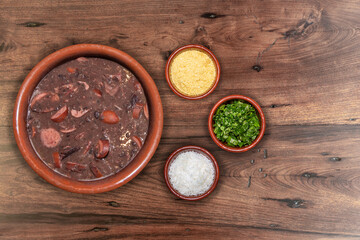 Delicious feijoada bowl with side dishes. Brazilian typical cuisine made with black beans and pork