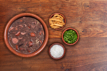 Delicious feijoada bowl with side dishes. Brazilian typical cuisine made with black beans and pork