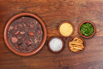 Obraz na płótnie Canvas Delicious feijoada bowl with side dishes. Brazilian typical cuisine made with black beans and pork