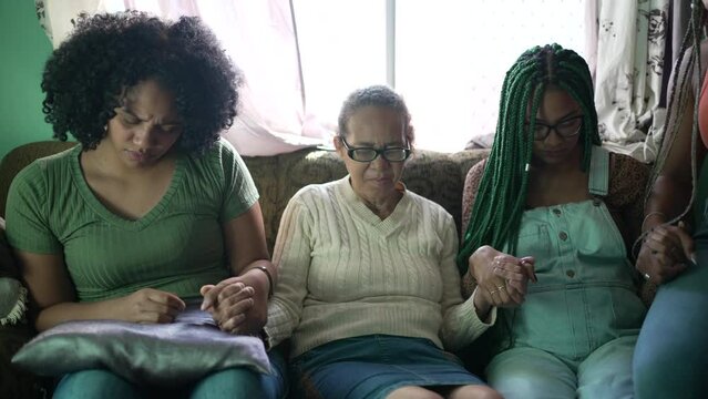 A hispanic family praying at home together. South American people in prayer having HOPE and FAITH