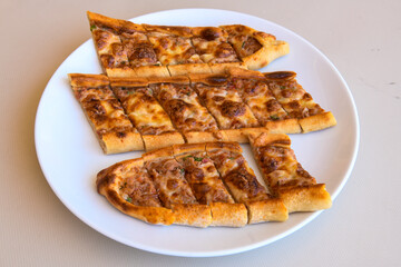 Turkish pita with minced cubed meat and cheese (Turkish name: Kiyma Kusbasi kasarli pide)