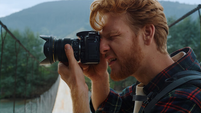Closeup hipster make picture using photo camera on river bridge mountains hike.