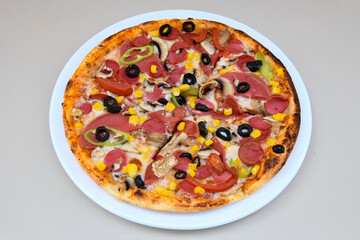 Delicious mixed pizza with rich content. Menu concept of choice and diversity