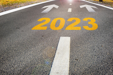 Year 2023 with arrow sign marking on road surface for future ahead. Business challenge concept and...