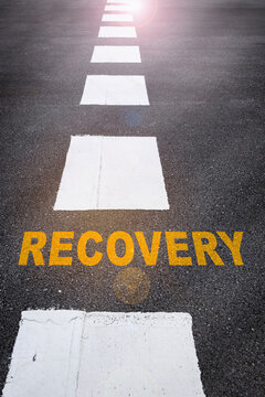 Recovery written on the road. Business success concept and challenge idea