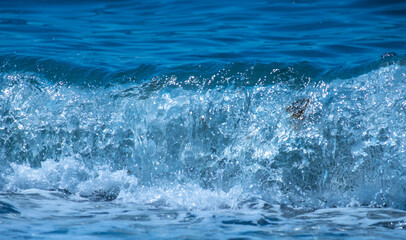 Ocean waves crashing on sandy beach. Sea waves breaking on shore.