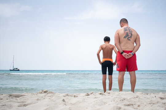 Uncle and nephew on a beach in Menorca on a summer day