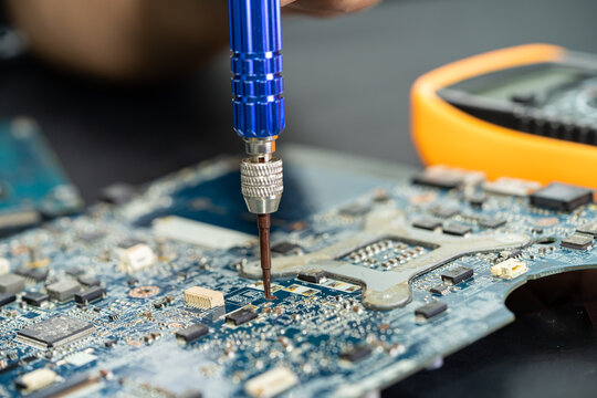 Technician repairing inside of mobile phone. Integrated Circuit. the concept of data, hardware, technology.