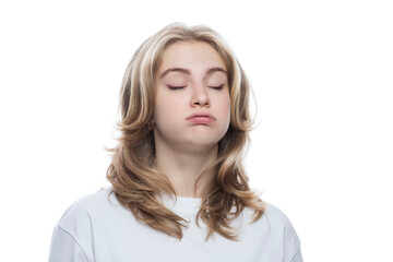 Naklejka premium Tired teenage girl in a white T-shirt with her eyes closed. Stress and load. Isolated on white background. Close-up.